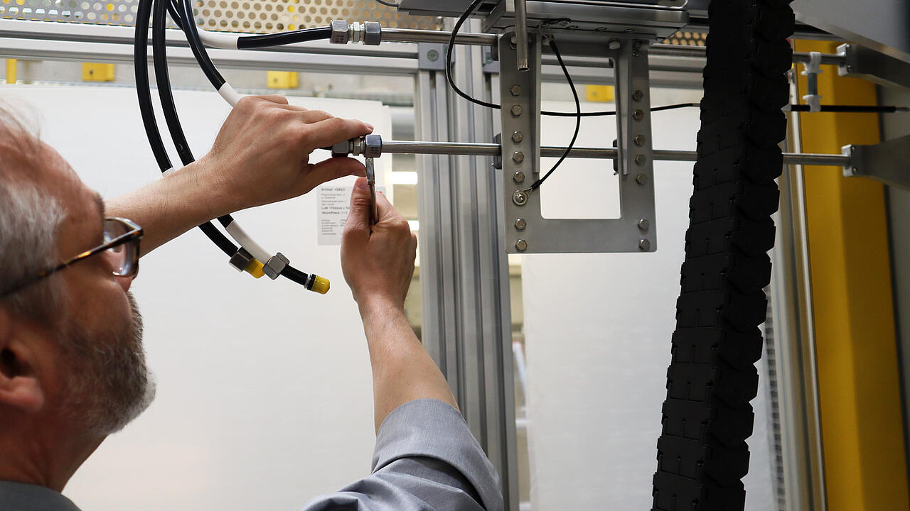 Engineer working on a test system (filter scanner) with a screwdriver